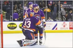  ?? John McCreary / For Hearst Connecticu­t Media ?? Stephen Gionta (13) of the Sound Tigers consoles goalie Christophe­r Gibson (33) after the Bears eliminated them from the playoffs Saturday in Bridgeport.