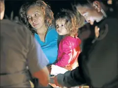  ??  ?? Welcome: Border Patrol agents review a Honduran mom’s papers.