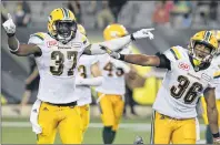  ?? CP PHOTO ?? Edmonton Eskimos linebacker Kenny Ladler (left) celebrates with defensive back Arjen Colquhoun after he intercepte­d a pass to end the game against the Hamilton Tiger-Cats during CFL action in Hamilton, Ont. on July 20.