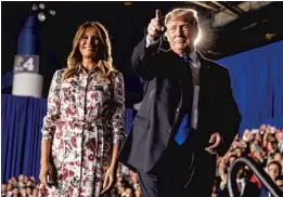  ?? ANDREW HARNIK/AP ?? President Donald Trump and first lady Melania Trump take the stage at Florida Ocean Bank Convocatio­n Center at Florida Internatio­nal University in Miami.