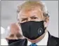  ?? PATRICK SEMANSKY/AP ?? A masked President Trump visited Walter Reed National Military Medical Center on Saturday.