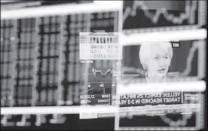  ?? AP ?? The Washington news conference of Federal Reserve chair Janet Yellen is reflected in a specialist’s screen on the floor of the New York Stock Exchange.