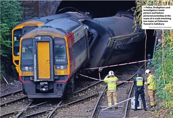  ?? Steve Parsons/Press Associatio­n ?? Police, firefighte­rs and investigat­ors (main picture and below) pictured yesterday at the scene of a crash involving two trains at Fisherton Tunnel in Salisbury