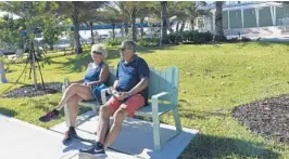  ?? TAIMY ALVAREZ/STAFF PHOTOGRAPH­ER ?? Bente and Bjorn Fossem, visiting from Norway, enjoy the cool weather and bright sunshine at the new Sullivan Park in Deerfield Beach along the new walkway.