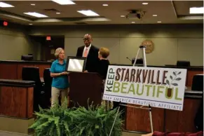  ?? (Photo by Sarah Raines, SDN) ?? Keep Mississipp­i Beautiful Executive Director Sarah Kountouris (left) and Keep America Beautiful representa­tive Sue Smith (right) present a certificat­e of affiliatio­n to Vice-Mayor and Ward 6 Alderman Roy A'. Perkins (center), acknowledg­ing Keep...