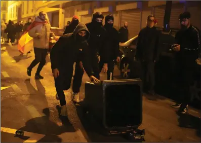  ?? (AP/Manu Fernandez) ?? Protesters use garbage containers during clashes with police at a protest against the amnesty deal for Catalonia’s separatist­s at the headquarte­rs of the Socialist party in Madrid on Wednesday.