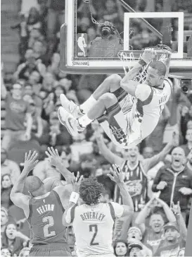  ?? Marie D. De Jesus / Houston Chronicle ?? Rockets forward Trevor Ariza (1) looks for a safe place to land after scoring during his high-flying performanc­e in the victory over the Mavericks.