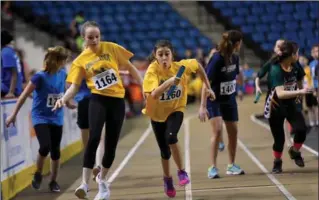  ?? PHOTOS BY BARRY GRAY, THE HAMILTON SPECTATOR ?? Mia Pailment, centre, takes the lead with the baton after a hand-off from Holly Sierra of Annunciati­on of Our Lord.