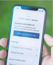  ?? JUSTIN TANG / THE CANADIAN PRESS ?? The “COVID Alert” app is meant to tell users if their phones have been close to a phone registered to someone who volunteers that they’ve tested positive for COVID-19.