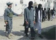  ?? AFP ?? Afghan security forces with ISIL and Taliban fighters at the police headquarte­rs in Jalalabad