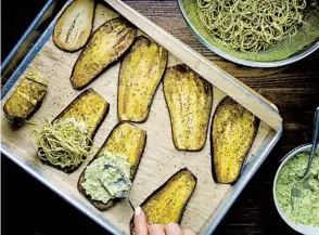  ?? ?? Cook the pasta to al dente. Drain, rinse with cold water to stop cooking, then toss with pesto sauce to taste. Mix the ricotta with pesto, mozzarella and Parmesan. Spread the ricotta mixture onto the fat end of the eggplant. Add a handful of pasta, bunched up in a ball. Tightly roll up the eggplant, stopping seam-side down.