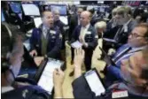  ?? RICHARD DREW — THE ASSOCIATED PRESS ?? Specialist Robert Nelson, second left, works with traders on the floor of the New York Stock Exchange, Wednesday. U.S. stocks sank again Wednesday as investors worried about tariffs and rising trade tensions.