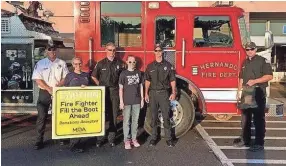  ?? SUBMITTED PHOTO ?? From left, Lt. Tony Harris, paramedic Marci Chapman, driver Robert Ashe; MDA patient and local MDA ambassador Hannah Warren, firefighte­r Chad Ray and firefighte­r Austin Crawford pose for a photo July 21 during Hernando Fire Department's Fill the Boot...