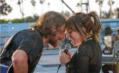  ?? Neal Preston / Warner Bros. via Associated Press ?? Bradley Cooper and Lady Gaga in a scene from the latest reboot of “A Star is Born,” which is Cooper’s directoria­l debut.