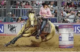  ?? Steve Gonzales / Houston Chronicle ?? Kassie Mowry and her horse, Firewaterm­akesmehapp­y, registered a winning round of 14.06 seconds in barrel racing Saturday at NRG Stadium.