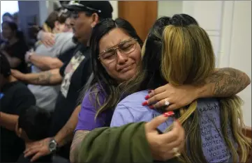  ?? ?? FILE - Family members of the victims of the Uvalde shootings react after a Texas House committee voted to take up a bill to limit the age for purchasing AR-15style weapons in the full House in Austin, Texas, Monday, May 8, 2023. Families in Uvalde, Texas, are digging in for a new test of legal protection­s for the gun industry as they mark one year since the Robb Elementary School shooting. Both the U.S. government and gun manufactur­ers in recent years have reached large settlement­s following some of the nation’s worst mass shootings. (AP Photo/Eric Gay, File)