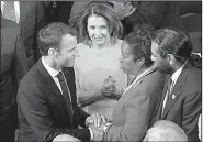  ?? AP/J. SCOTT APPLEWHITE ?? French President Emmanuel Macron, escorted by House Minority Leader Nancy Pelosi (center), is greeted Wednesday by Reps. Sheila Jackson Lee and Al Green, both Texas Democrats, as Macron arrives to address Congress.