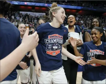  ?? JESSICA HILL — THE ASSOCIATED PRESS ?? UConn’s Katie Lou Samuelson, center, is cheered on by her teammates after she was announced as the Most Outstandin­g Player for the AAC tournament on Monday at Mohegan Sun Arena in Uncasville.