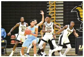  ?? (Pine Bluff Commercial/I.C. Murrell) ?? Jayden Saddler (5) of Southern University faces defensive pressure from Shaun Doss Jr. (21), Alvin Stredic Jr. (15) and Jalen Lynn (1) of the University of Arkansas at Pine Bluff during the second half on Saturday at H.O. Clemmons Arena.