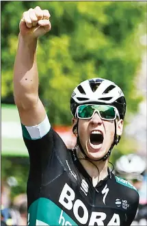 ??  ?? Germany’s Pascal Ackermann celebrates as he crosses the finish line to win the second stage in the 70th edition of the Criterium du Dauphine cycling race
between Montbrison and Belleville, southeaste­rn France on June 5. (AFP)