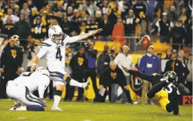  ?? Justin K. Aller / Getty Images ?? The Chargers’ Michael Badgley kicks the game-winner to end it in Pittsburgh. Artie Burns (25) was offside, the third time a Steelers player jumped the snap.