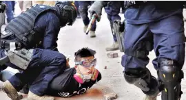  ?? PHOTO: REUTERS ?? A protester is detained by riot police at Mong Kok in Hong Kong on Monday