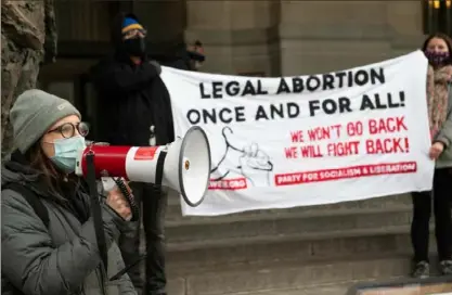  ?? Emily Matthews/Post-Gazette photos ?? Stephanie Pavlick, of Bloomfield, an organizer with Party for Socialism and Liberation, speaks to those gathered during an Internatio­nal Women’s Day Rally on Tuesday outside the City-County Building, Downtown.