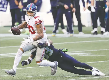  ?? GETTY IMAGES ?? The Giants' Evan Engram evades a tackle and takes off after making a catch against the Seahawks during the fourth quarter Sunday.