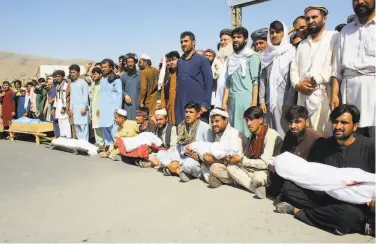  ?? Mehrab Ibrahimi / Associated Press ?? Residents carry bodies of those killed in an air strike during a protest in Baghlan, northern Afghanista­n.