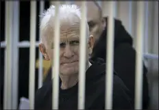  ?? VITALY PIVOVARCHY­K — ASSOCIATED PRESS FILE ?? Ales Bialiatski, the leader of the Belarusian Vyasna rights group, sits in a defendants’ cage during a court session in Minsk, Belarus, on Jan. 5. A Belarusian court has sentenced Bialiatski, Belarus’ top human rights advocate and one of the winners of the 2022Nobel Peace Prize, to 10years in prison.