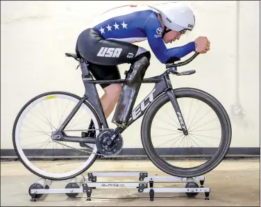  ?? Arkansas Democrat-Gazette/JOHN SYKES JR. ?? Little Rock’s Jason Macom works out on indoor rollers. Macom recently won a paracyclin­g national championsh­ip in the pursuit track event.