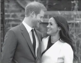  ??  ?? Prince Harry and Meghan Markle announce their engagement in The Sunken Gardens at Kensington Palace on Monday in London.