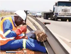  ?? ?? A man works on the rehabilita­tion of barricades on the bridge-over-rail along Mutare Road near Mabvuku in Harare recently. The Government, through the Ministry of Transport and Infrastruc­tural Developmen­t, is maintainin­g and reconstruc­ting roads and bridges. — Picture: Kudakwashe Hunda