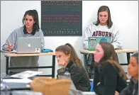  ?? TNS ?? Twelfth-graders Shelby Stansbury (left) and Sarah Kate Farmer use standing desks in a recent class at the Episcopal School of Dallas in Dallas, Texas.