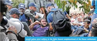  ??  ?? Israeli police evict settlers in the Netiv Haavot neighbourh­ood of the Elazar settlement, south of Jerusalem, yesterday. — AFP
