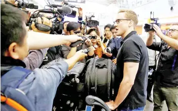  ?? —Reuters photo ?? CNN’s Will Ripley talks to the media after arriving at the aiport to board a plane to North Korea in Beijing.