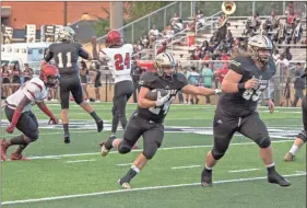  ?? Photos by TIM GODBEE / For the Calhoun Times ?? ( ABOVE) Calhoun’s Zack Fuller (24) runs behind the block of Elijah Baldridge (65) in the first quarter on Friday. ( BOTTOM) Calhoun’s Bralin Barton (4) breaks away from the Therrell defense on a punt return for a touchdown in the first half.