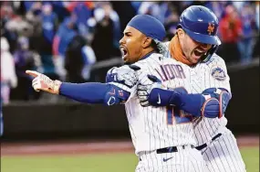  ?? Bill Kostroun / Associated Press ?? The Mets’ Francisco Lindor (12) celebrates with Pete Alonso after hitting a single to drive in the winning run in the 10th inning on Tuesday against the Giants.