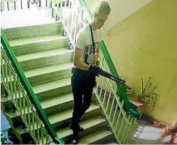  ??  ?? Vladislav Roslyakov stalks through the Crimean school where he killed 19 students and wounded more than 50 others.