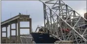  ?? KAITLIN NEWMAN — THE BALTIMORE BANNER VIA AP ?? The site of the collapsed Francis Scott Key Bridge and the container ship that toppled it, Dali, are seen from a debris retrieval vessel, the Reynolds, April 4.