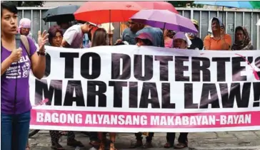  ?? TED ALJIBE/AFP ?? A protester speaks during a rally in front of the Supreme Court in Manila yesterday.