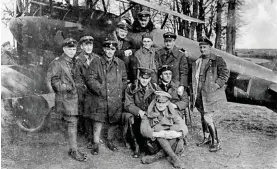  ??  ?? ABOVE: Von Richthoven in the cockpit of his famous Rotes Flugzeug (‘Red Aircraft’) with other members of Jasta 11, including his brother Lothar (sitting, front), in April 1917.
BELOW: The remains of Baron von Richthoven’s Fokker DR1 tri-plane at the aerodrome of No. 3 Squadron of the Australian Flying Corps at Bertangles, Somme, Picardie (France). Note white fabric on rudder. BOTTOM: Canadian fighter pilot, Arthur ‘Roy’ Brown (far right), prepares to lay a wreath at the full military funeral bestowed upon the Red Baron by the Allies.