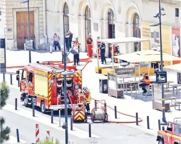  ??  ?? French fire brigade and police are seen outside the Gare Saint Charles train station which was evacuated after an alert. — Reuters photo