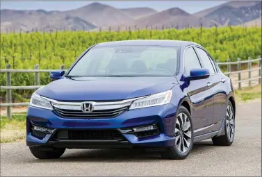  ?? AMERICAN HONDA MOTOR CO., INC. VIA AP ?? This photo provided by American Honda Motor Co., Inc. shows the 2017 Honda Accord Hybrid. Honda’s Accord Hybrid returns for 2017 as a roomy, comfortabl­e, mid-size sedan that’s the most fuel-efficient gasoline-electric hybrid four-door car in its class.
