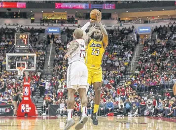  ?? USA TODAY SPORTS ?? Lakers forward LeBron James shoots the ball over the Rockets’ PJ Tucker.