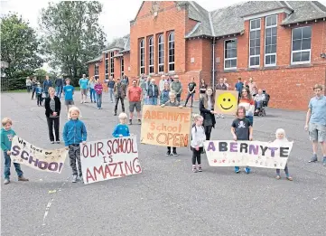  ??  ?? CLASS ACTION: Campaigner­s celebrate after Perth and Kinross Council’s decision to close Abernyte Primary School was overturned by the Scottish Government.