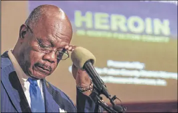  ?? JOHN SPINK /JSPINK@AJC.COM ?? Fulton County DA Paul Howard looks over his notes before releasing the findings of a study on the heroin crisis in Fulton County earlier this year at Lindsay Street Baptist Church in Atlanta . Officials spoke about the epidemic in the state and city...