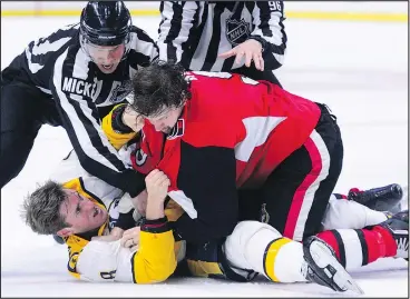 ?? — CP ?? Referees pull Ottawa Senators’ Bobby Ryan off of Nashville Predators’ Kyle Turris as they fall to the ice while duking it out during Monday’s game in Ottawa.