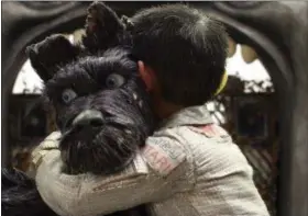  ?? COURTESY OF FOX SEARCHLIGH­T PICTURES ?? The friendship of a boy (voice of Koyu Rankin) softens the heart of a stray dog (voice of Bryan Cranston) in Wes Anderson’s stop-motion animation picture “Isle of Dogs.”