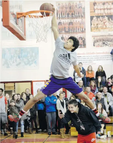  ?? DON HEALY/Leader-Post ?? Jashon Henry from Saskatoon’s St. Joseph high school leaps over teammate Owen Weiss while competing in the dunk
contest at the Fekula Senior Basketball Classic at Balfour Collegiate Friday. Henry won the contest.